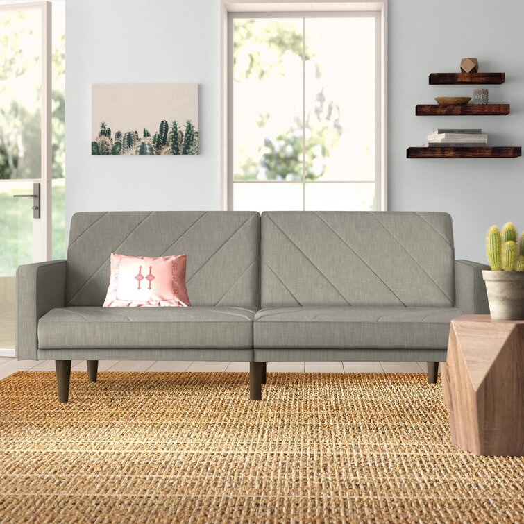 Versatile sofa with independent reclining back sections in a spacious living room.