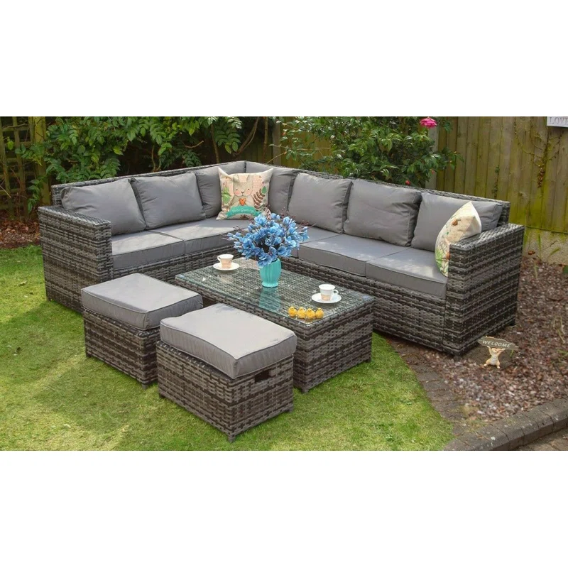 Outdoor sectional sofa set arranged in an L-shape configuration on a stone patio.