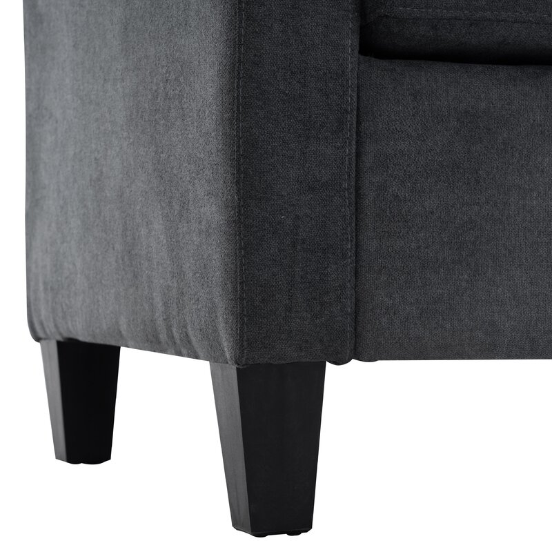 Ottoman placed as a footrest in front of the wide modular sofa