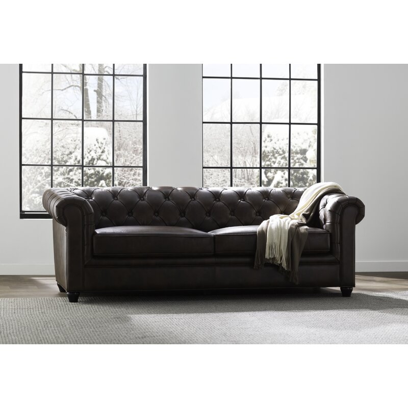 Traditional living room sofa with high rolled arms and leather upholstery