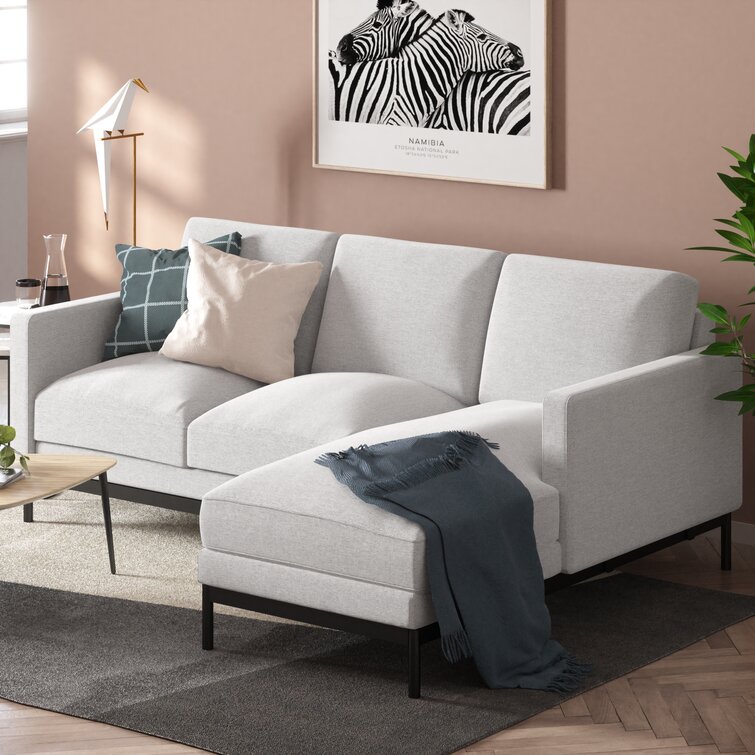 Wide comfortable sectional couch with extended chaise for relaxing.