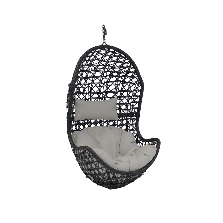 A cozy single person porch swing hanging on a covered porch.