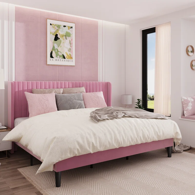 A classic tufted wingback bed frame in a neutral fabric.