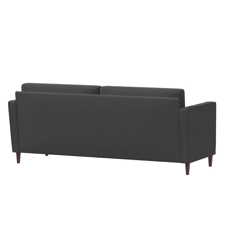 Neutral colored sofa with square arms and decorative cushions.