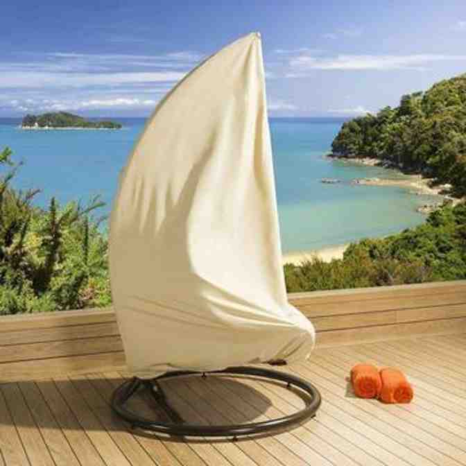 Set of two pod chairs and a table arranged on a patio