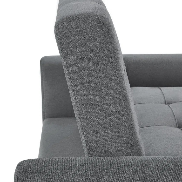 Dark gray fabric sofa bed with decorative button tufting.