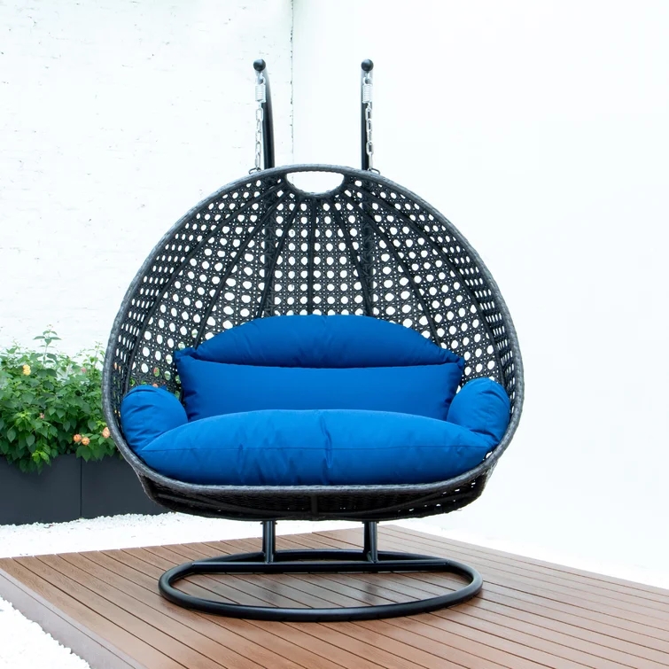 A two-person porch swing hanging from a covered patio.