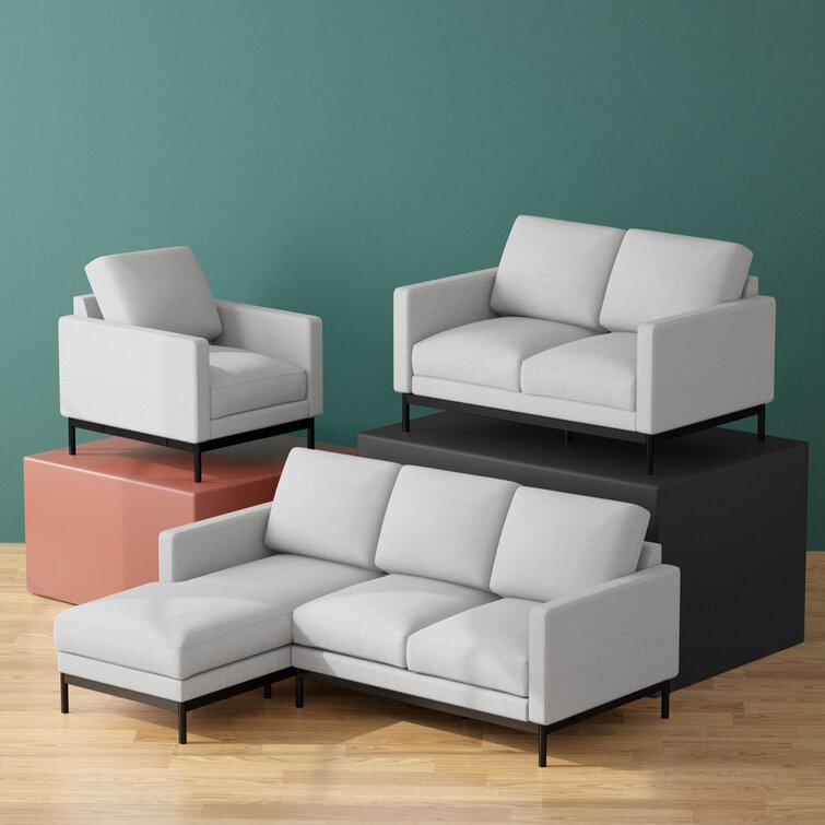 A modern L-shaped reversible sectional sofa with a chaise lounge in a living room.