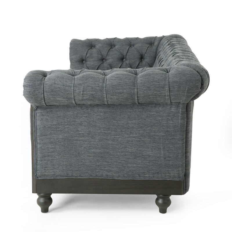 Button tufted leather sofa with deep seating and rolled arms
