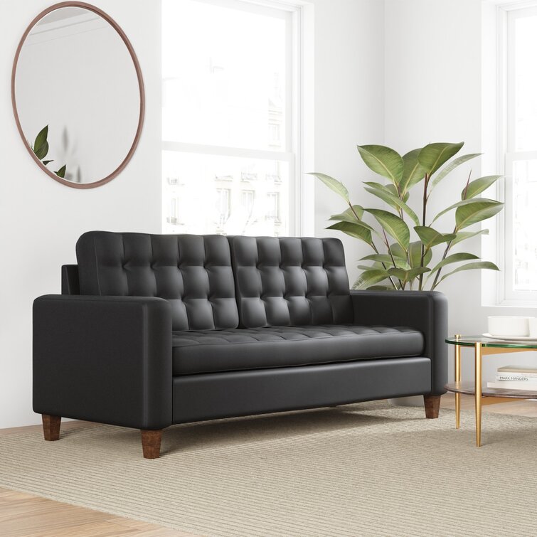 A contemporary sofa with square arms in a vegan leather fabric