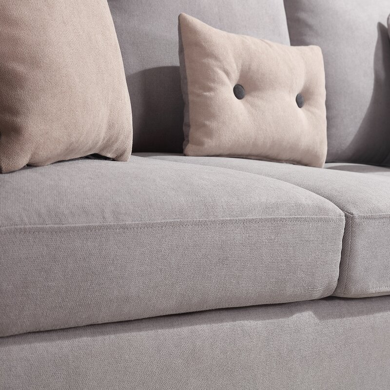 Modern light gray reversible L-shaped sectional sofa in a contemporary living room.