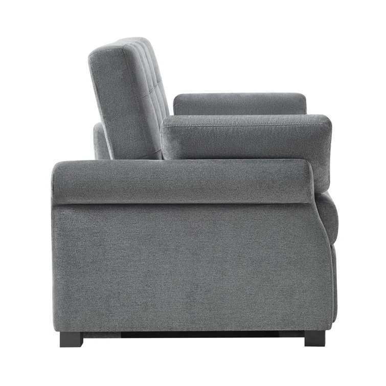 A modern dark gray sleeper sofa with a tufted back and rolled arms.