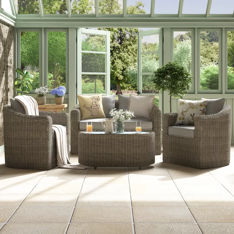 Rattan sofa set with cushions on a patio