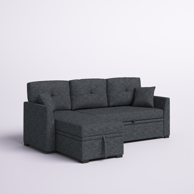 A large gray upholstered sleeper sofa with a chaise lounge in a modern living room.