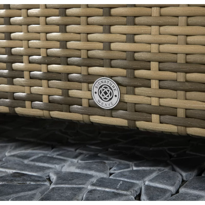 Close-up view of the textured all-weather wicker material and cushion stitching.