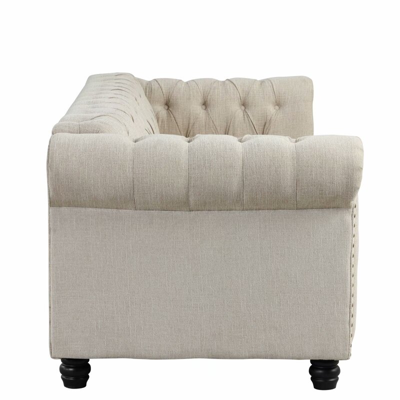 Timeless tufted sofa with scrolled arms