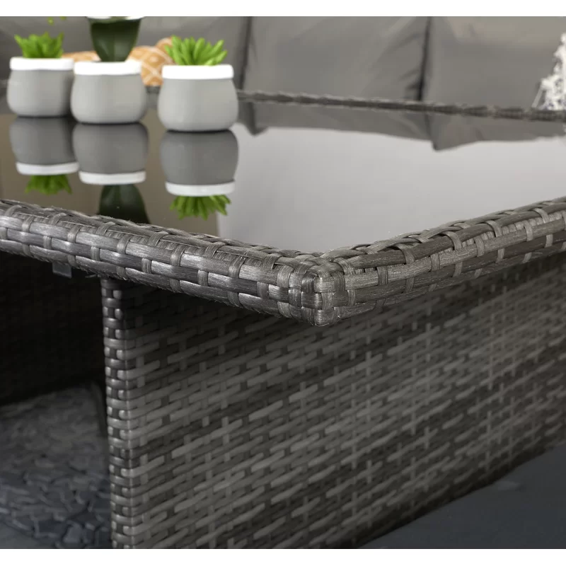 The patio lounge set fully arranged with plush cushions on a deck.