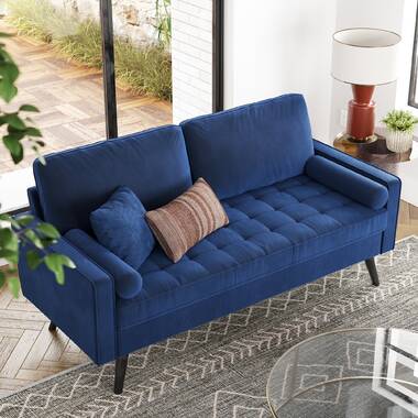 Gray fabric sofa with tailored square arms and button tufting detail.