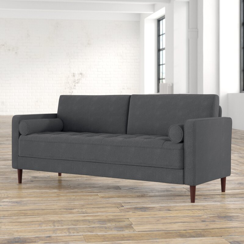 Fabric sectional with square arms and chaise lounge.