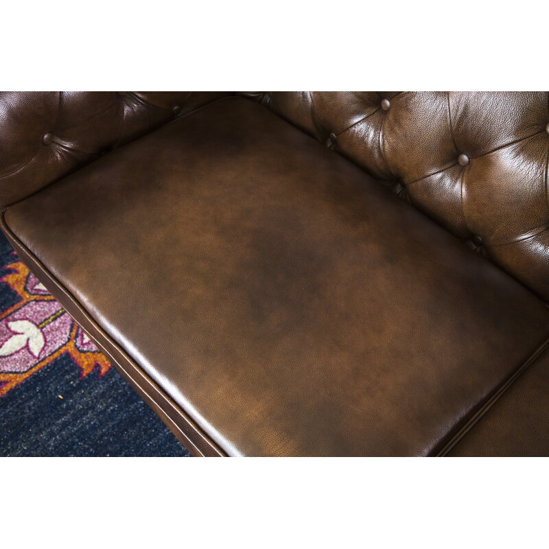 Detailed shot of the sofa's signature rolled arm and nailhead trim