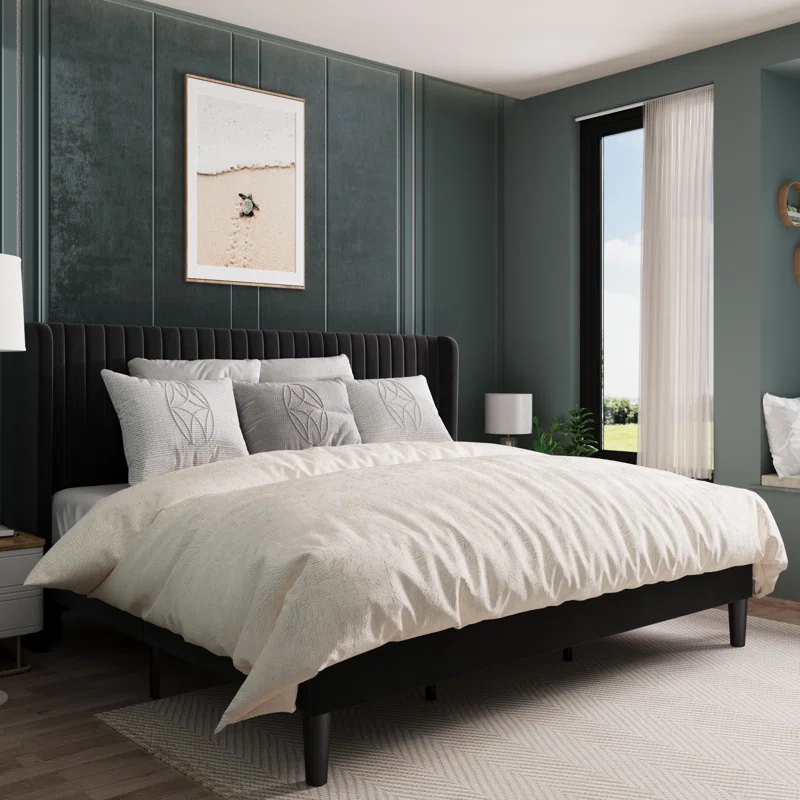 Upholstered bed with a tall, wingback style headboard.