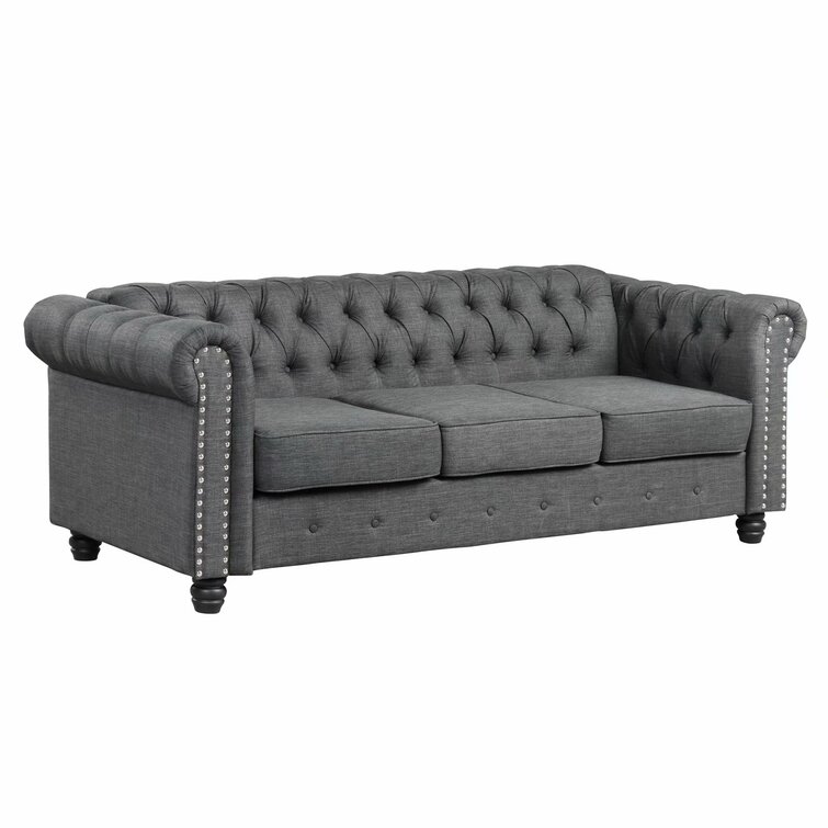 Classic leather Chesterfield sofa with deep button tufting