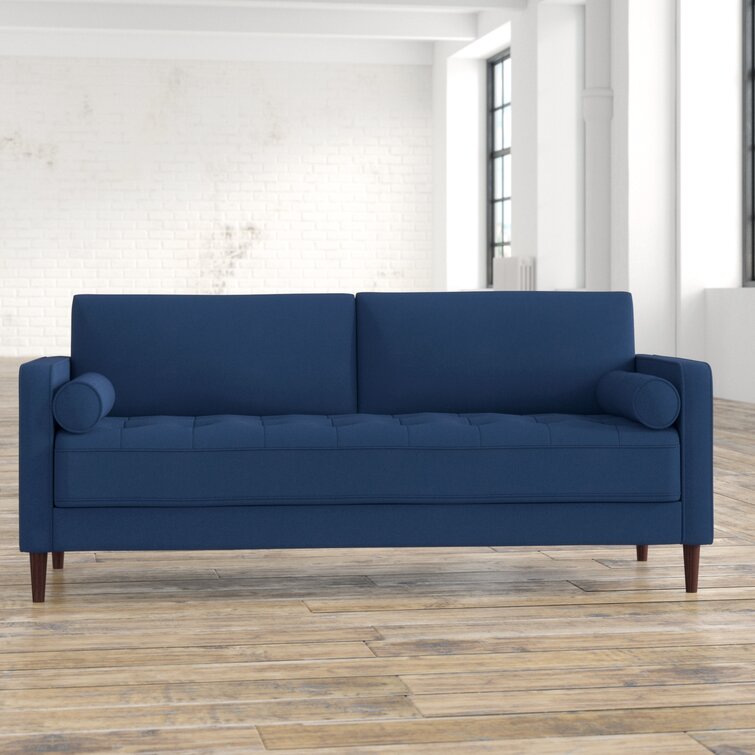 Cozy seating with tufted upholstery and structured square armrests.