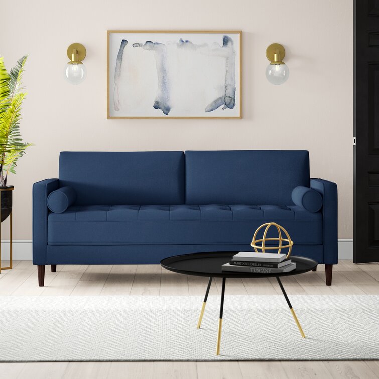 Tufted back and seat cushions on a sturdy square-arm sofa frame.
