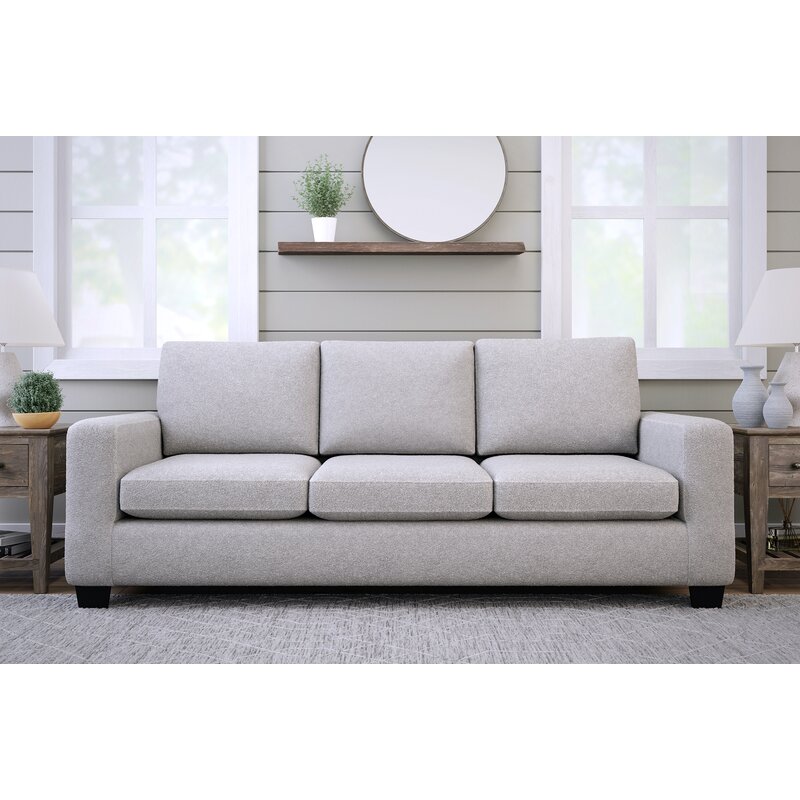 Stylish sofa with square arms and neutral fabric upholstery
