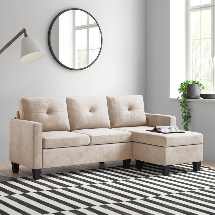 Gray reversible sectional sofa with chaise positioned in a modern lounge