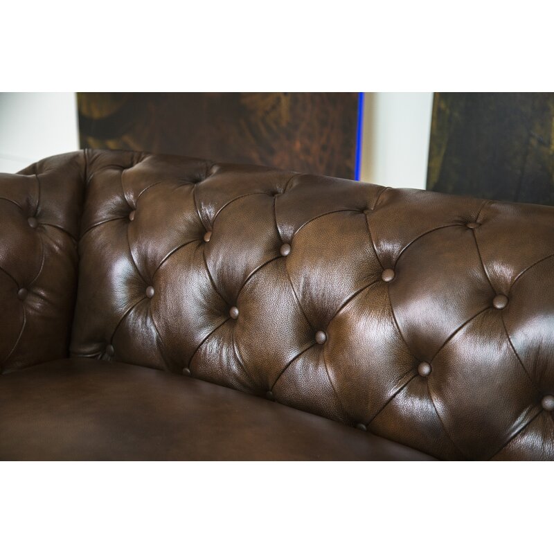 Brown leather sofa featuring a sturdy hardwood frame and comfortable seating