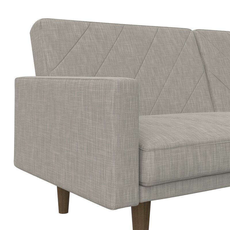 Convertible sofa bed with split back design shown in a contemporary setting.