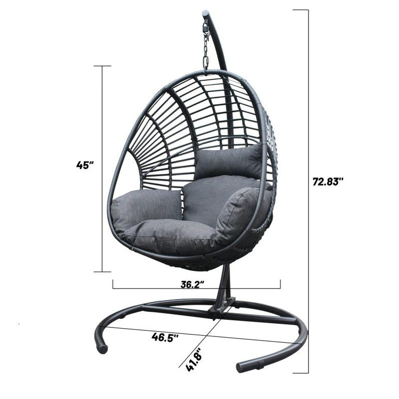 The swing chair in a cozy indoor corner by a window.