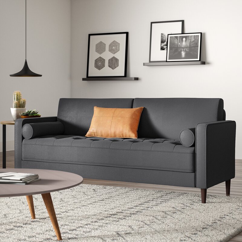 Stylish grey square arm sectional sofa in a contemporary lounge.