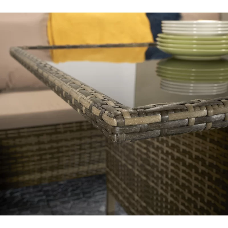 Outdoor wicker sectional sofa set arranged in an L-shape configuration.