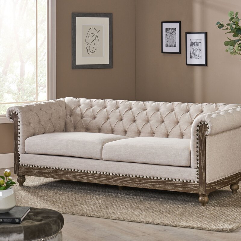 Rolled arm sofa in genuine brown leather with nailhead trim