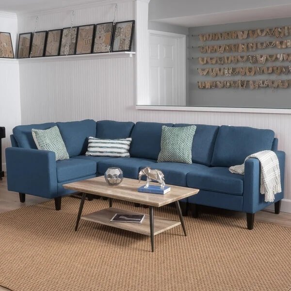 A modern L-shaped fabric sectional sofa in a neutral color.