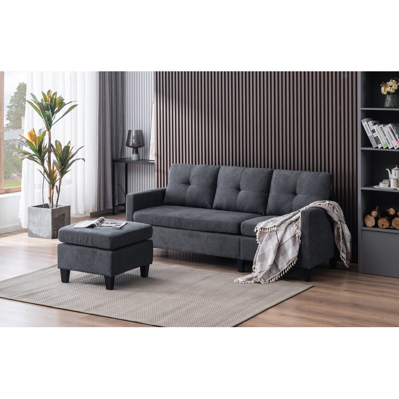 Gray reversible sectional sofa with chaise positioned in a modern lounge